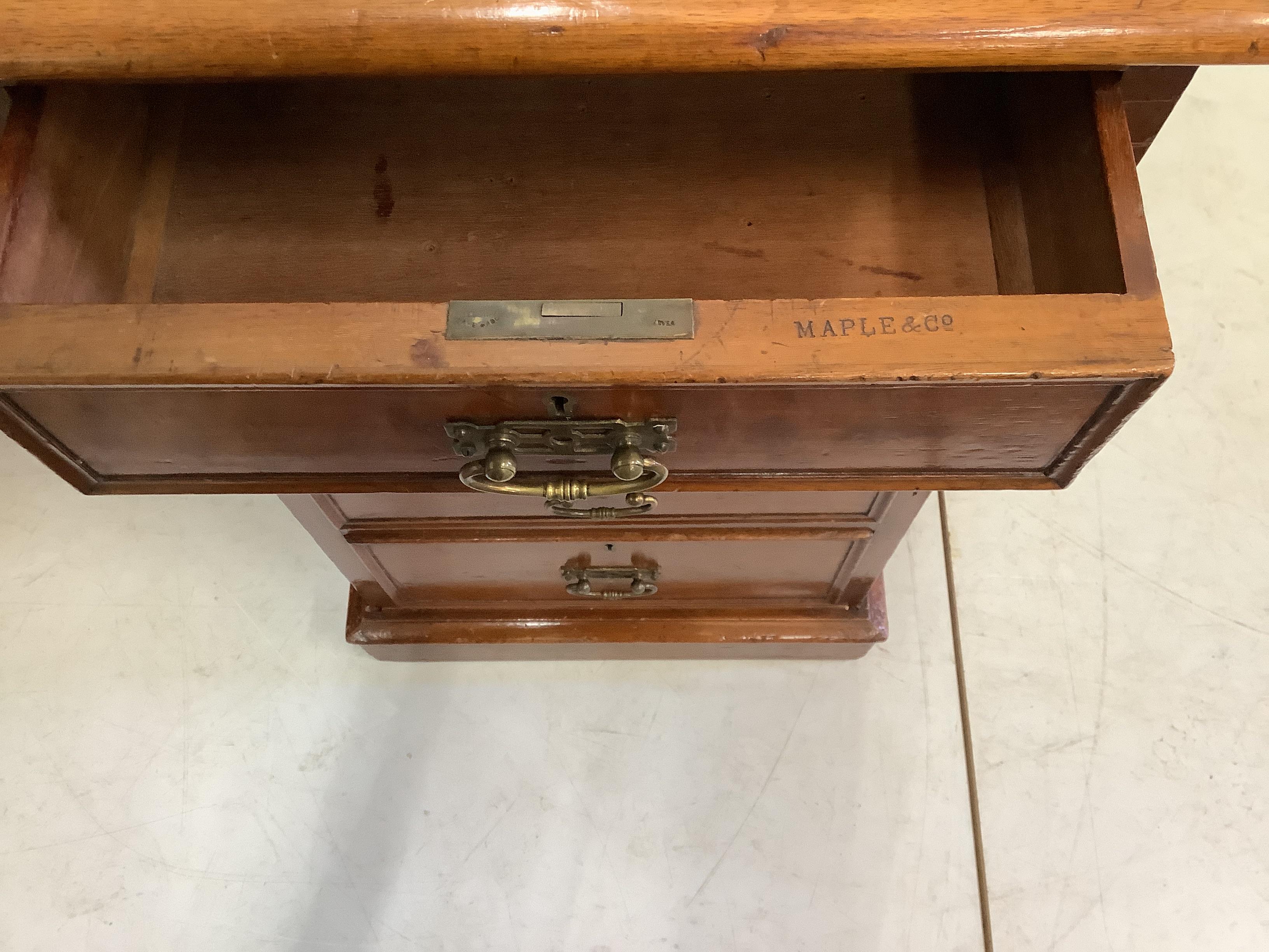 A late Victorian mahogany pedestal desk by Maple and Co., width 137cm, depth 74cm, height 74cm